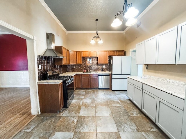 211 W Saunders St, Trenton, TX 75490 - kitchen featuring stainless steel appliances, wall chimney exhaust hood, a chandelier, ornamental molding, and light countertops