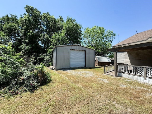 211 W Saunders St, Trenton, TX 75490 - view of green lawn with an outdoor structure, a garage, and driveway