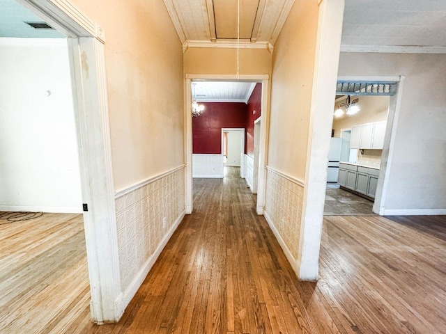 211 W Saunders St, Trenton, TX 75490 - hallway with attic access, crown molding, hardwood / wood-style floors, and a wainscoted wall