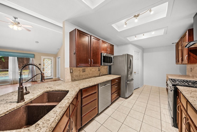 741 Oak Dale Ave, Lake Dallas, TX 75065 - kitchen with a sink, appliances with stainless steel finishes, tasteful backsplash, and light tile patterned flooring
