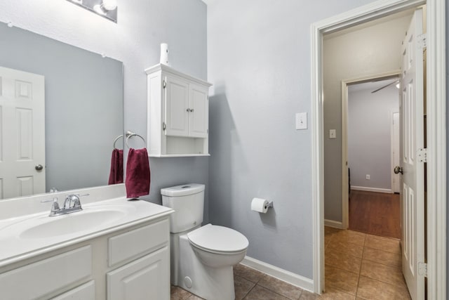 5708 Pebble Ridge Dr, Mckinney, TX 75070 - half bathroom with toilet, vanity, tile patterned floors, and baseboards