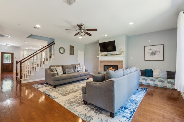 5708 Pebble Ridge Dr, Mckinney, TX 75070 - living room featuring baseboards, hardwood / wood-style floors, stairway, a ceiling fan, and a tiled fireplace