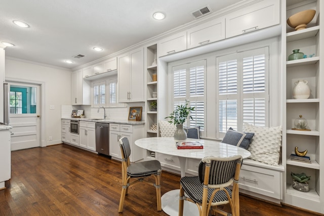 5510 Monticello Ave, Dallas, TX 75206 - dining room with ornamental molding, recessed lighting, dark wood finished floors, and built in shelves