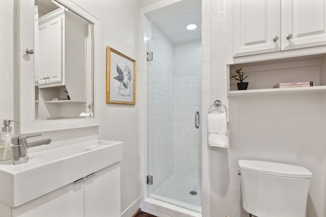 5510 Monticello Ave, Dallas, TX 75206 - bathroom featuring toilet, vanity, and a shower stall