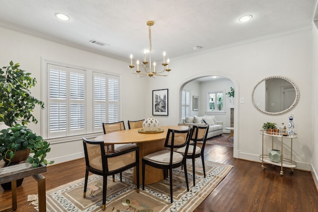 5510 Monticello Ave, Dallas, TX 75206 - dining space with arched walkways, a chandelier, baseboards, dark wood-style floors, and ornamental molding