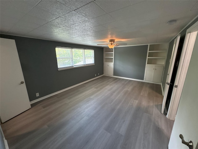 2401 N Alexander St, Sherman, TX 75092 - unfurnished bedroom with wood finished floors, baseboards, and ceiling fan