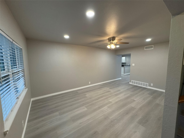 2401 N Alexander St, Sherman, TX 75092 - empty room featuring ceiling fan, baseboards, wood finished floors, and recessed lighting