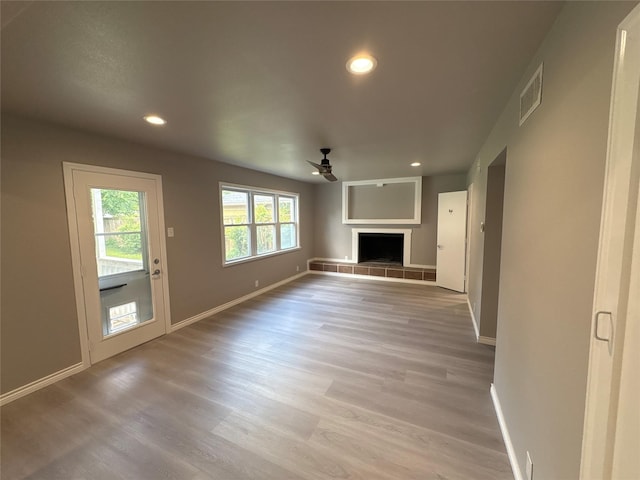 2401 N Alexander St, Sherman, TX 75092 - unfurnished living room featuring ceiling fan, baseboards, recessed lighting, light wood finished floors, and a fireplace