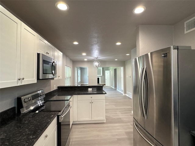 2401 N Alexander St, Sherman, TX 75092 - kitchen with appliances with stainless steel finishes, recessed lighting, light wood-type flooring, a peninsula, and white cabinetry