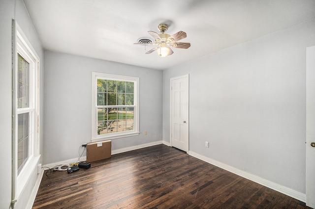 702 W Simmons St, Weatherford, TX 76086 - unfurnished room featuring dark wood finished floors, baseboards, and a ceiling fan