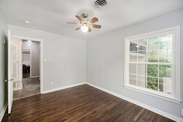 702 W Simmons St, Weatherford, TX 76086 - spare room featuring dark wood-style floors, ceiling fan, and baseboards