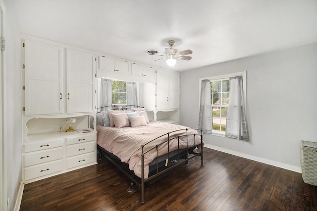 702 W Simmons St, Weatherford, TX 76086 - bedroom featuring dark wood-style floors, baseboards, and a ceiling fan