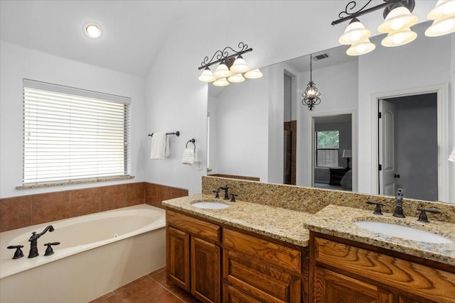 106 Versailles Ln, Aledo, TX 76008 - bathroom with a garden tub, double vanity, a chandelier, lofted ceiling, and tile patterned flooring
