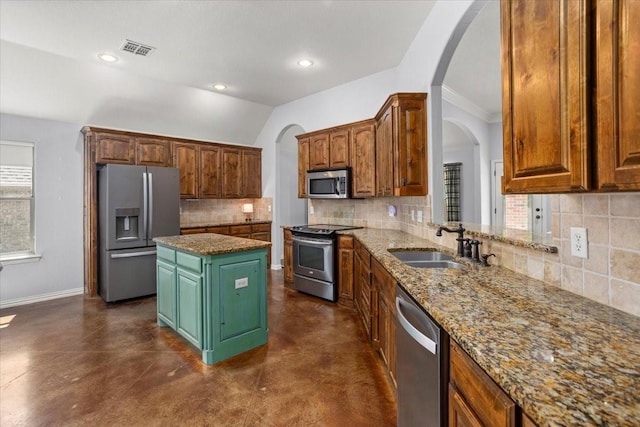 106 Versailles Ln, Aledo, TX 76008 - kitchen with appliances with stainless steel finishes, concrete flooring, arched walkways, recessed lighting, and ornamental molding