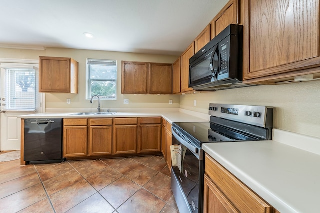 12916 Gillon Dr, Frisco, TX 75035 - kitchen with black appliances, a sink, brown cabinets, light countertops, and recessed lighting