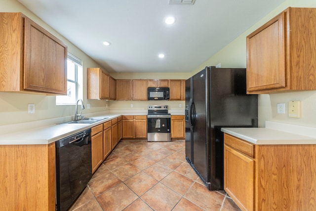 12916 Gillon Dr, Frisco, TX 75035 - kitchen with black appliances, a sink, recessed lighting, and light countertops