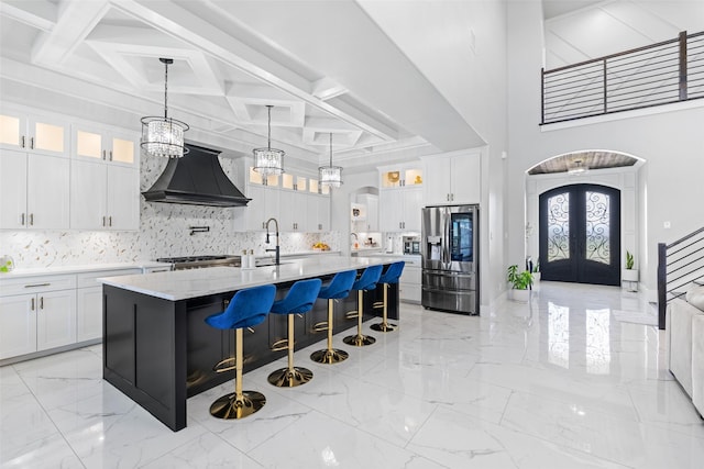 10901 Chriswood Dr, Crowley, TX 76036 - kitchen with stainless steel fridge with ice dispenser, premium range hood, coffered ceiling, decorative backsplash, and a sink