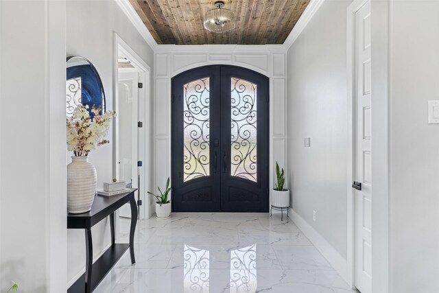 10901 Chriswood Dr, Crowley, TX 76036 - foyer with french doors, wood ceiling, crown molding, arched walkways, and light marble finish flooring