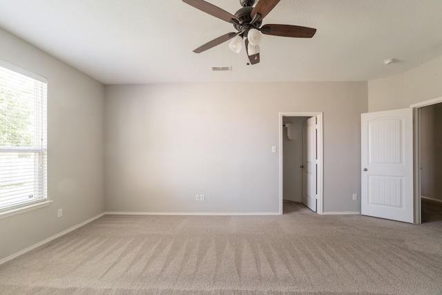 9233 Benevolent Ct, Providence Village, TX 76227 - unfurnished bedroom with light colored carpet, multiple windows, and a walk in closet