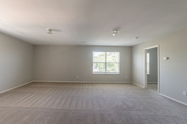 9233 Benevolent Ct, Providence Village, TX 76227 - empty room featuring light carpet and baseboards