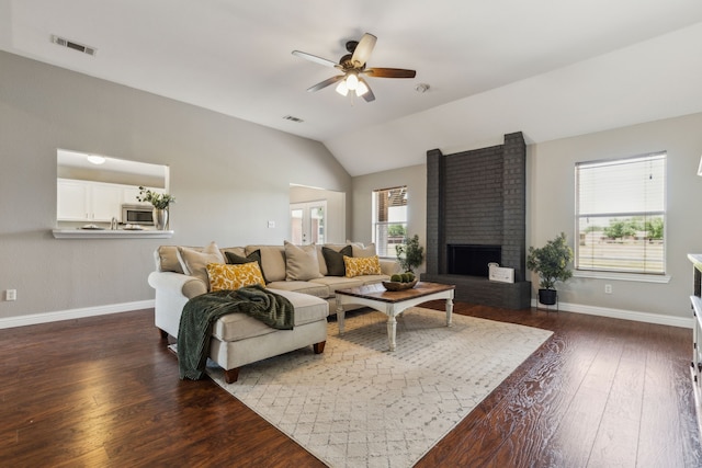 830 Cross Timbers Dr, Lowry Crossing, TX 75069 - living area with baseboards, dark wood finished floors, ceiling fan, vaulted ceiling, and a brick fireplace