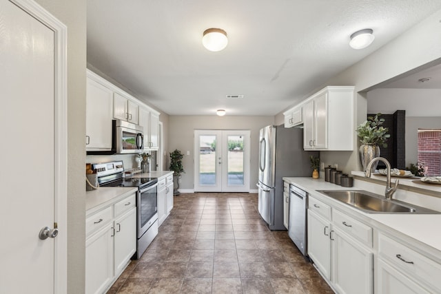 830 Cross Timbers Dr, Lowry Crossing, TX 75069 - kitchen with stainless steel appliances, a sink, french doors, white cabinets, and light countertops