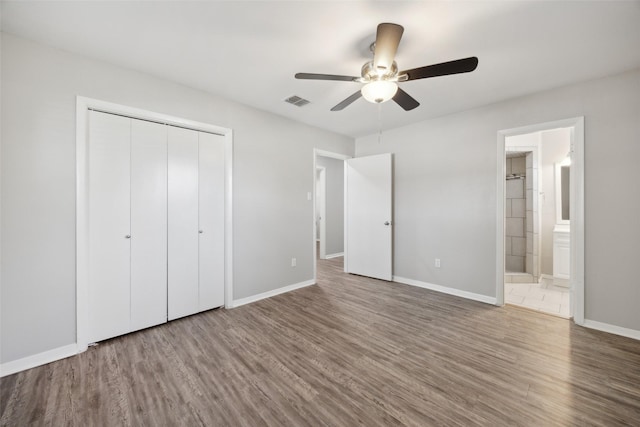 104 W Mistletoe Dr, Kennedale, TX 76060 - unfurnished bedroom with wood finished floors, a closet, baseboards, ceiling fan, and ensuite bath