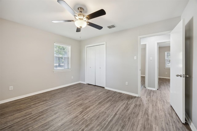 104 W Mistletoe Dr, Kennedale, TX 76060 - unfurnished bedroom featuring wood finished floors, a closet, baseboards, and ceiling fan