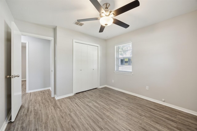 104 W Mistletoe Dr, Kennedale, TX 76060 - unfurnished bedroom with wood finished floors, baseboards, a closet, and ceiling fan