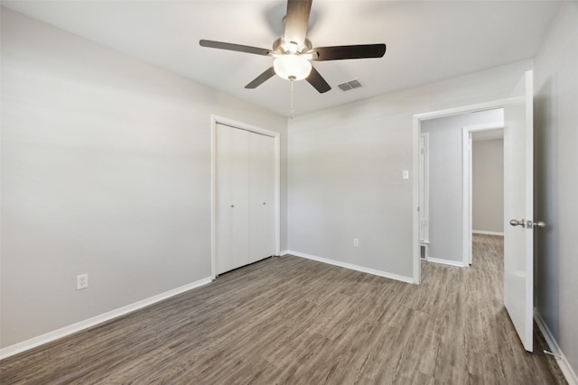 104 W Mistletoe Dr, Kennedale, TX 76060 - unfurnished bedroom with wood finished floors, a closet, baseboards, and ceiling fan