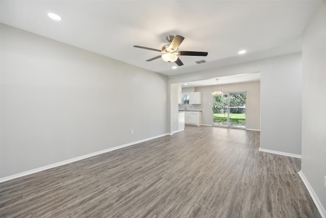 104 W Mistletoe Dr, Kennedale, TX 76060 - unfurnished living room with a ceiling fan, wood finished floors, baseboards, recessed lighting, and a chandelier