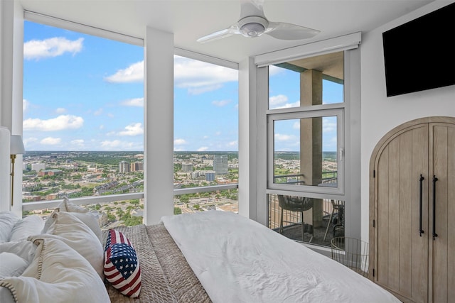 500 Throckmorton St Unit 2707, Fort Worth, TX 76102 - bedroom featuring a city view, expansive windows, and a ceiling fan
