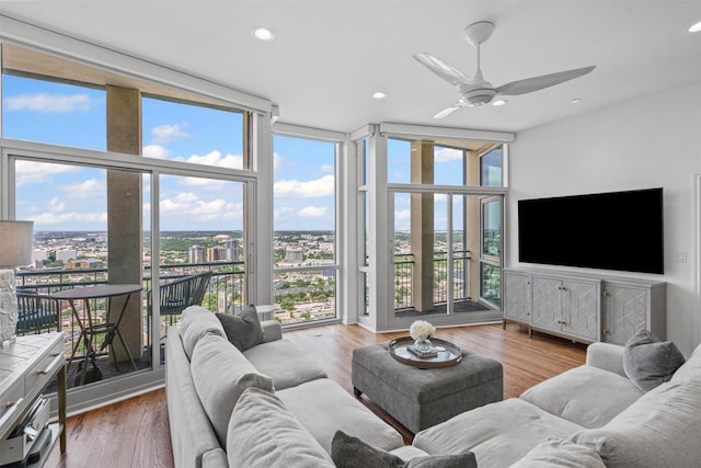 500 Throckmorton St Unit 2707, Fort Worth, TX 76102 - living area with expansive windows, healthy amount of natural light, a ceiling fan, recessed lighting, and wood finished floors