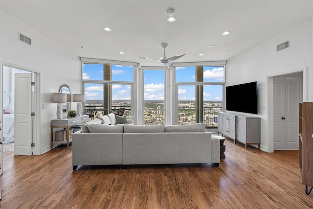 500 Throckmorton St Unit 2707, Fort Worth, TX 76102 - living area with ceiling fan, wood finished floors, recessed lighting, expansive windows, and baseboards