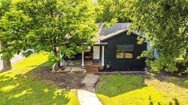 1917 E Mulberry St, Sherman, TX 75090 - view of front of property featuring a front yard, a shingled roof, and a porch