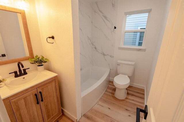 1917 E Mulberry St, Sherman, TX 75090 - full bathroom featuring toilet, wood finished floors, vanity, and bathtub / shower combination
