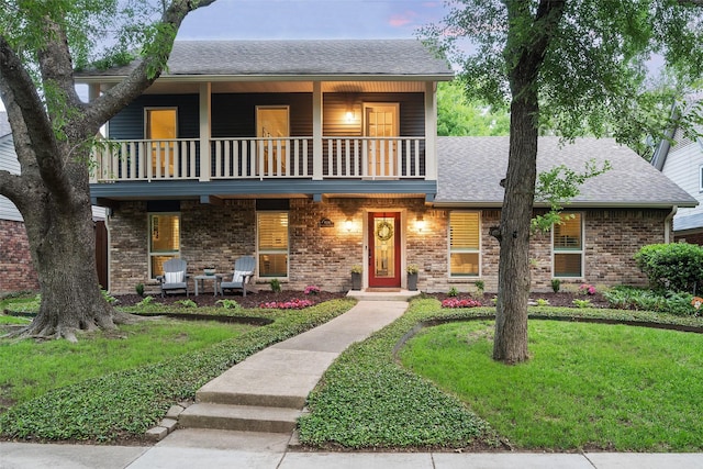 9030 Summer Glen Ln, Dallas, TX 75243 - view of front of home with a balcony, roof with shingles, a front lawn, and brick siding
