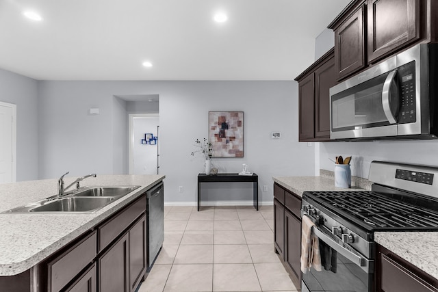 16316 Caledonia Ct, Justin, TX 76247 - kitchen featuring appliances with stainless steel finishes, a sink, dark brown cabinets, baseboards, and light countertops