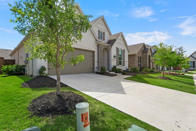 2020 Rhea Ct, Celina, TX 75009 - view of front facade featuring concrete driveway, brick siding, and a front yard