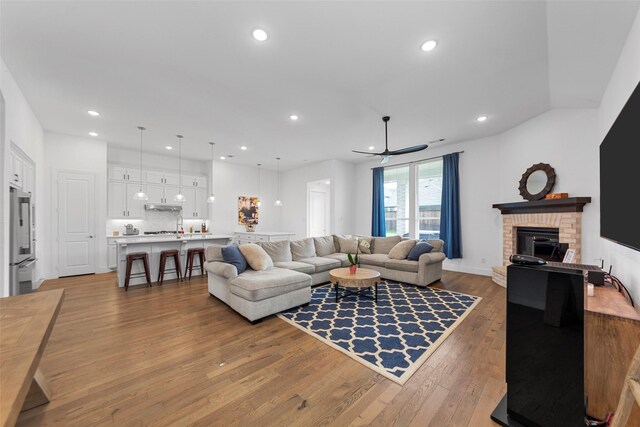 2020 Rhea Ct, Celina, TX 75009 - living room with light wood finished floors, ceiling fan, a fireplace, and recessed lighting