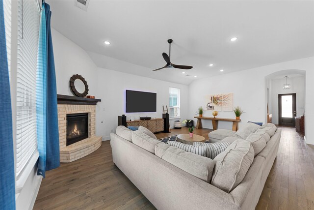 2020 Rhea Ct, Celina, TX 75009 - living room with arched walkways, ceiling fan, a brick fireplace, wood finished floors, and recessed lighting