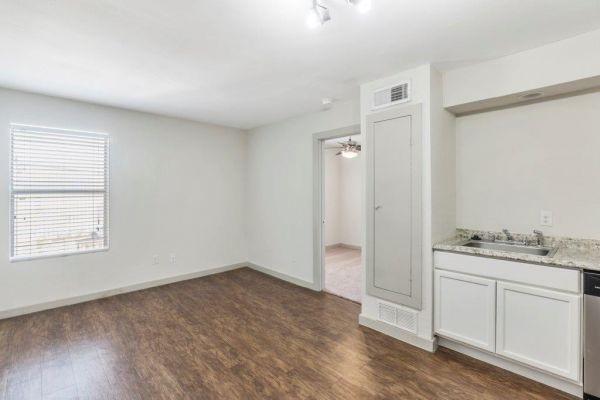 2320 W Prairie St, Denton, TX 76201 - unfurnished room with a sink, dark wood finished floors, and baseboards