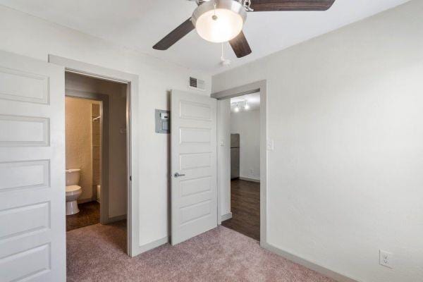 2320 W Prairie St, Denton, TX 76201 - unfurnished bedroom with carpet, baseboards, and a ceiling fan