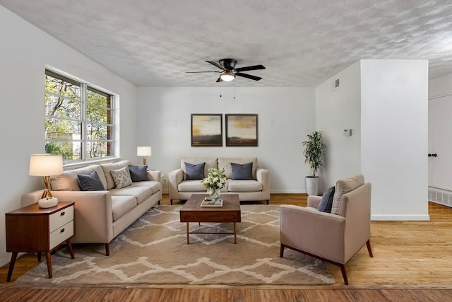 2549 Inadale Ave, Dallas, TX 75228 - living area with ceiling fan, wood finished floors, a textured ceiling, and baseboards