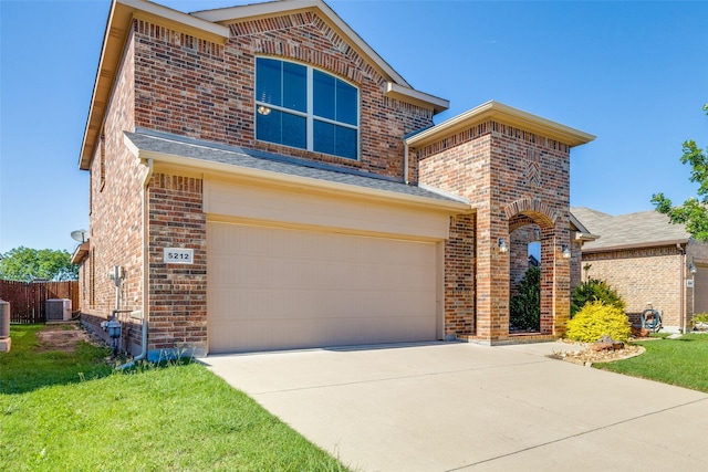 5212 Sugarcane Ln, Fort Worth, TX 76179 - view of front facade featuring brick siding, an attached garage, concrete driveway, central AC, and a front lawn