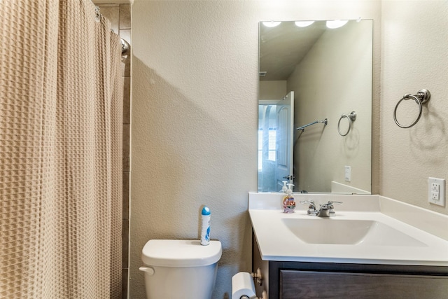 5212 Sugarcane Ln, Fort Worth, TX 76179 - bathroom featuring toilet, a textured wall, vanity, and a shower with curtain