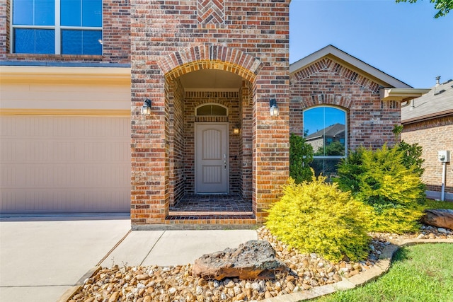 5212 Sugarcane Ln, Fort Worth, TX 76179 - property entrance with brick siding, an attached garage, and concrete driveway