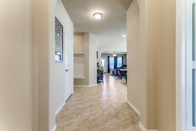 5212 Sugarcane Ln, Fort Worth, TX 76179 - hallway with arched walkways, baseboards, and light tile patterned floors
