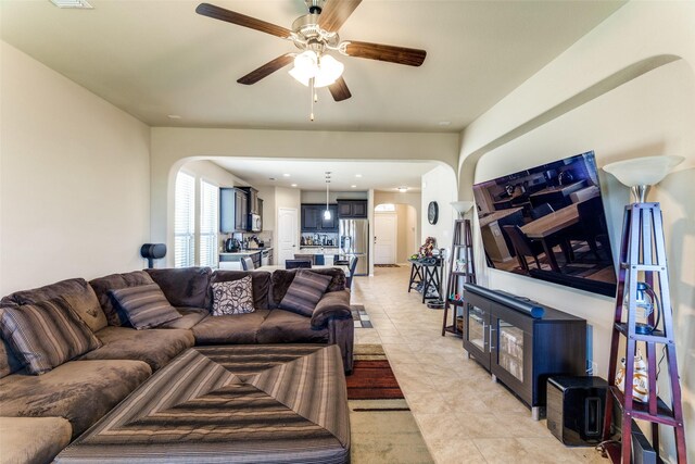 5212 Sugarcane Ln, Fort Worth, TX 76179 - living room with arched walkways, ceiling fan, and light tile patterned floors