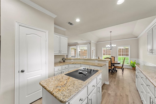1 Parkside Cir, Allen, TX 75013 - kitchen with black electric cooktop, crown molding, a chandelier, light wood-style floors, and recessed lighting